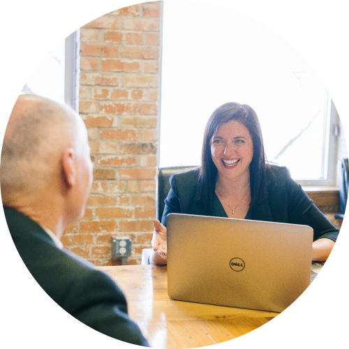 Therapist talking to a client and using Nebo to write Progress Notes